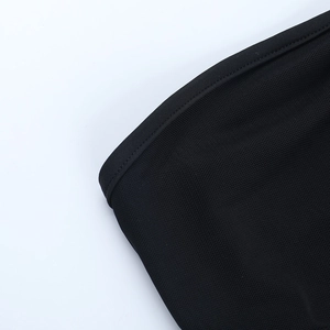 Close-up of black mesh fabric texture and knit detail on sexy halter neck bodysuit top