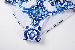 Detail of blue majolica pattern swimwear with white lining and precise stitching
