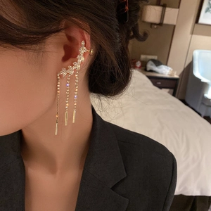Detail of silver leaf earring with cascading rhinestone tassels on a female model