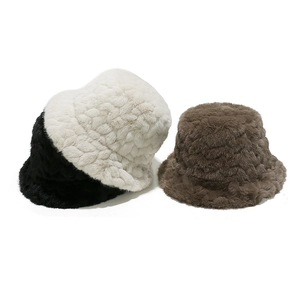 Winter plush bucket hats in black, cream, and brown with thick wavy texture for warmth