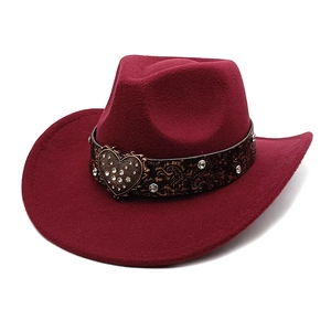 Detail of burgundy wool cowboy hat with leather band and heart-shaped rhinestone buckle