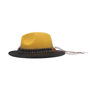 Detail of western cowboy hat with ethnic embroidery band and brown leather tassels