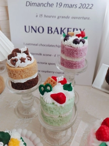 Close-up of double-layer strawberry and chocolate scented cake candles with realistic details
