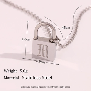 Polished stainless steel necklace with a gothic M engraved lock pendant on pink background