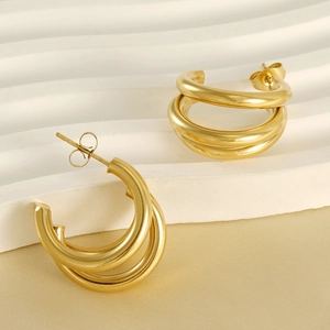 18K gold-plated multilayer stainless steel earrings on elegant silk background
