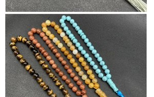 Detail of assorted natural stone beads including tiger eye and turquoise for DIY jewelry