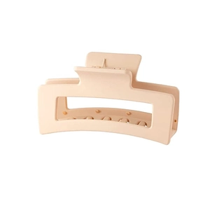 Detailed close-up of a matte beige rectangular hollow hair claw clip with a large size design