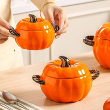 Detail of three orange ceramic pumpkin bowls with dark twisted handles in a bright kitchen