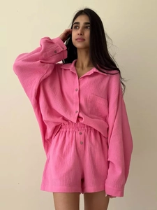Detail of pink long-sleeve gauze shirt and matching high-waist shorts set for women