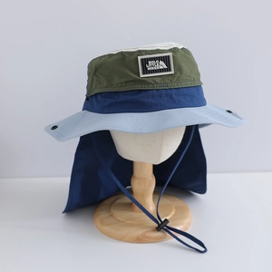 Detail of color-block sun hat with neck flap and adjustable chin strap for outdoors