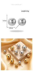 Detail showing polished metal ball earrings with dimensions and weight on silk background