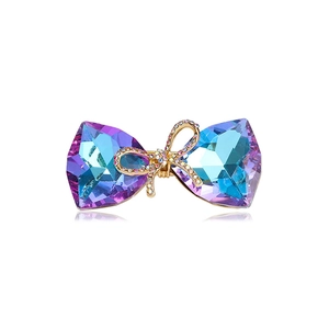 Sparkling crystal bow brooch featuring gradient rhinestones on a gold-plated base