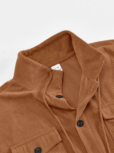 Detailed view of brown corduroy jacket collar and fabric texture with size M tag