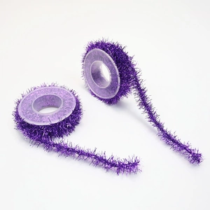 Close-up of purple tinsel garland rolls with metallic fiber texture for DIY crafts