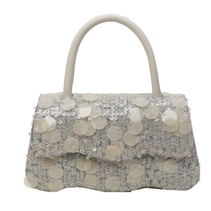 Fashionable silver sequined crossbody bag with a wavy flap and a beige top handle