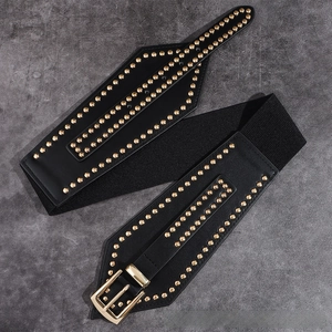 Close-up of black elastic waist belt with three rows of golden studs and metal buckle
