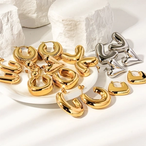 Polished gold and silver geometric hoop earrings in heart and C-shaped designs