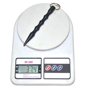 Tactical self-defense keychain rod with anti-slip bamboo grip on an electronic scale