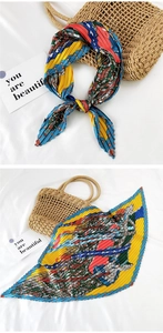 Detail of pleated silk scarf with colorful geometric patterns and wave edges