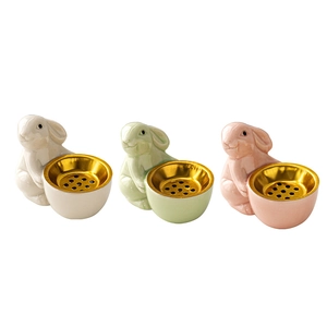 Three cute ceramic rabbit incense burners in white, green, and pink with gold metal bowls