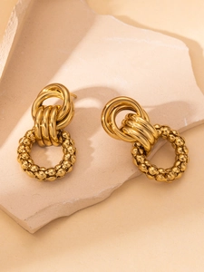 Detail of interlocking gold multi-ring earrings with beaded texture and polished finish