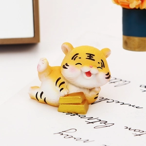 Cute fortune tiger car ornament lying on gold bars for dashboard or desk decor