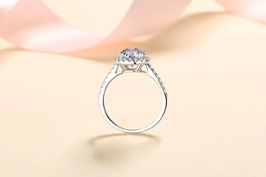 Macro shot of a purple round-cut gemstone ring with small diamonds on silver band