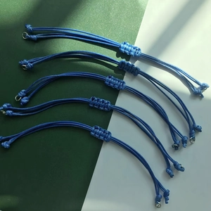 Detail of five blue braided wax cord bracelets with adjustable sliding knot closures