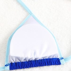 Detail of blue bikini top with contrast trim and adjustable halter straps on soft faux fur