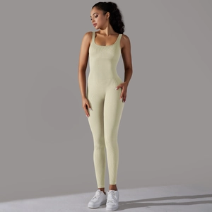 Detail of seamless ribbed yellow bodysuit featuring a wide neck and athletic fit