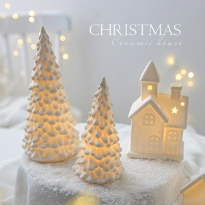 Luminous white ceramic Christmas tree and house tabletop ornaments with warm glowing lights