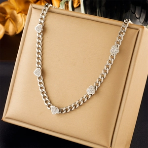 Elegant silver titanium chain necklace with sparkling heart diamond pendant on display