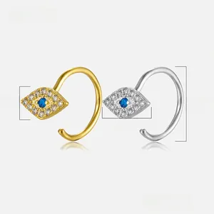 Detailed view of evil eye earrings in gold and silver finish with blue gemstones