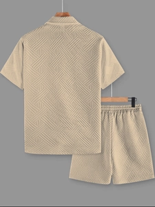 Detail of men's beige summer set showing textured waffle knit fabric and lapel shirt design