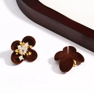 Close-up of vintage brown velvet flower stud earrings with sparkling zircon center