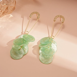 Elegant gold safety pin earrings with rhinestones and light green shell-textured pendants