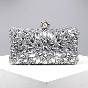 Detailed macro view of sparkling silver evening clutch with rhinestones and pearl clasp