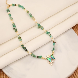 Handmade beaded necklace with natural green stones and a gold butterfly pendant jewelry