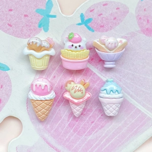 Close-up of assorted resin ice cream and sundae miniatures for DIY phone case decoration