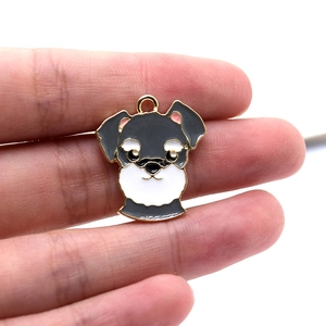Detailed view of a black and white schnauzer enamel pendant with golden metallic edges