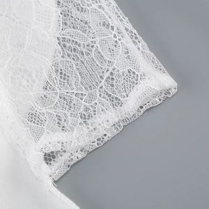 Detailed close-up of the delicate white lace floral pattern and hollow texture details