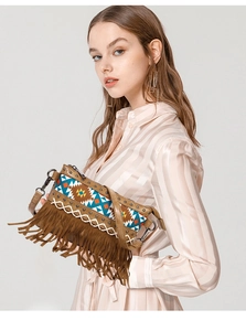 Detail of a brown tassel crossbody bag featuring colorful geometric woven patterns