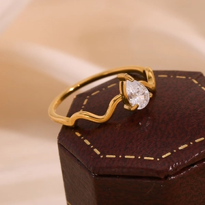 Macro detail of a 18K gold plated snake ring with a pear-shaped water drop diamond