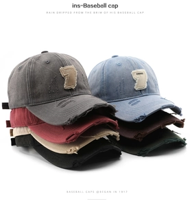 Detail shot of distressed vintage cotton baseball caps with torn edges and Change 7 patch
