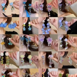 Floral and butterfly tassel earrings in vibrant colors showcased on multiple models