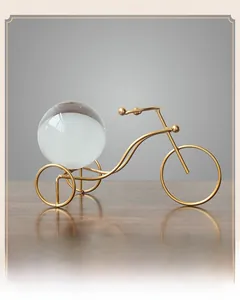 Close-up of golden metal tricycle ornament with large crystal ball for home decoration