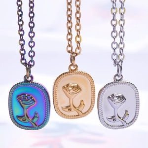 Three O-chain necklaces with embossed rose oval pendants in rainbow, gold, and silver finishes