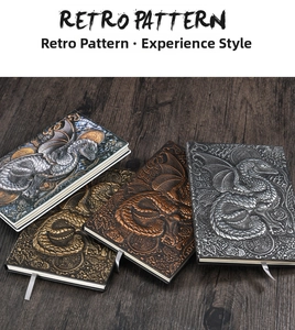 Macro detail of retro dragon embossed notebooks with high-relief texture on wood surface