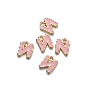 Detail view of five pink lightning bolt charms with gold trim and loops for jewelry DIY