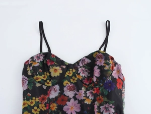 Detailed close-up of a floral camisole top with colorful patterns and thin straps